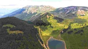 breathtaking aerial view of a tranquil mountain lake nestled in the heart of lush green valleys