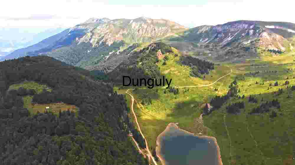 breathtaking aerial view of a tranquil mountain lake nestled in the heart of lush green valleys
