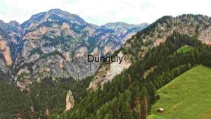 Alpine Majesty: A Solitary Hut Amidst Lush Meadows and Rugged Mountains