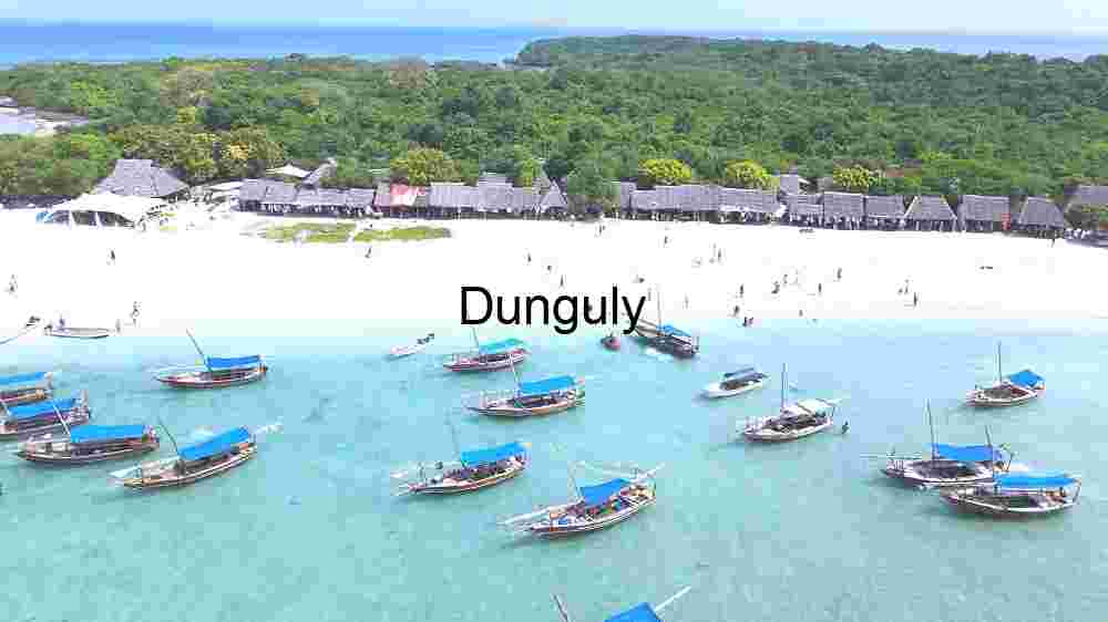 Tropical Beachside Village with Traditional Boats