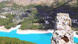 Serene Lakeside Landscape with Towering Rock Formation