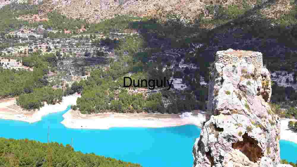 Serene Lakeside Landscape with Towering Rock Formation