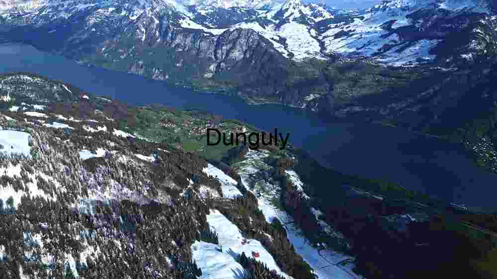 Alpine Serenity: Aerial View of a Snow-Capped Mountain Village by the Lake
