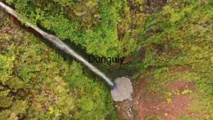 Aerial View of a Secluded Waterfall in Lush Greenery