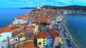 Picturesque Coastal Town with Terracotta Roofs and Serene Blue Sea