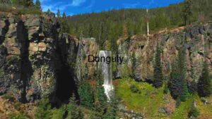 Majestic Waterfall in a Forested Canyon
