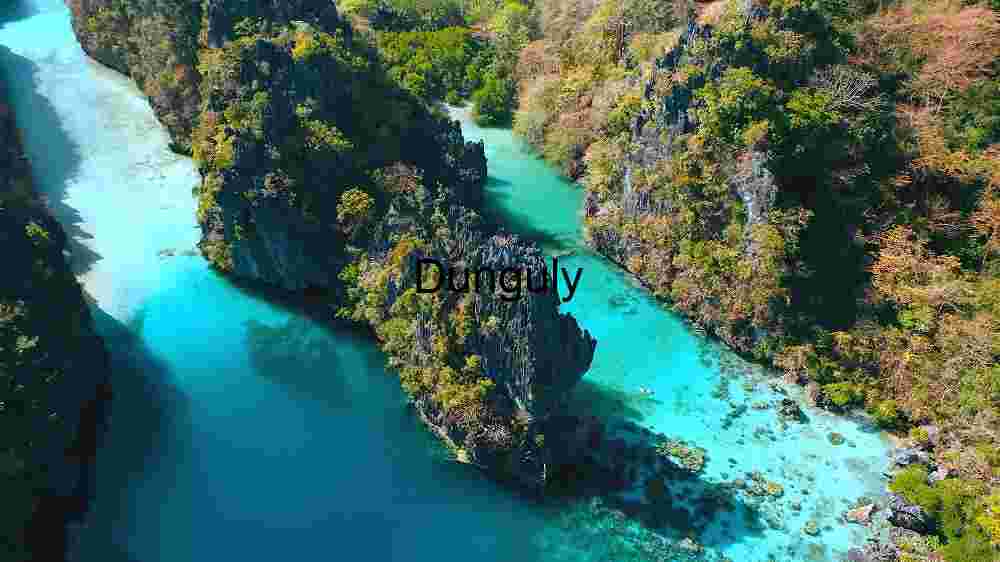 Aerial View of a Turquoise River Winding Through a Lush Green Canyon