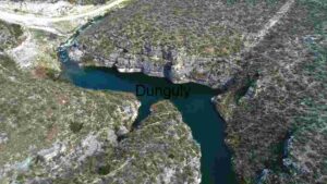 Aerial View of a Serene River Bend in a Rocky Landscape