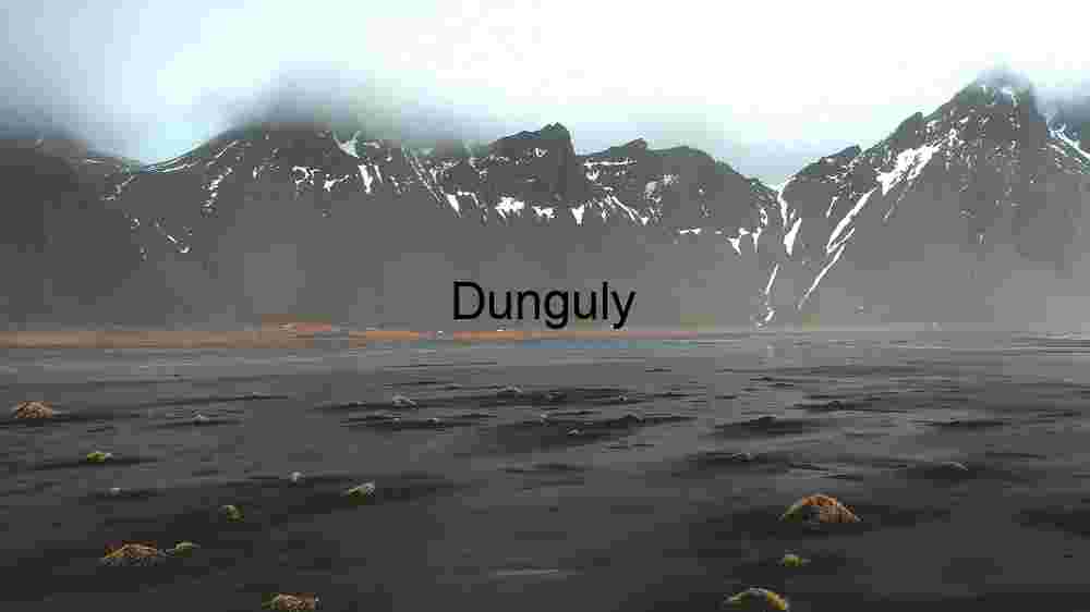 Majestic Mountain Range with Black Sand and Sparse Vegetation