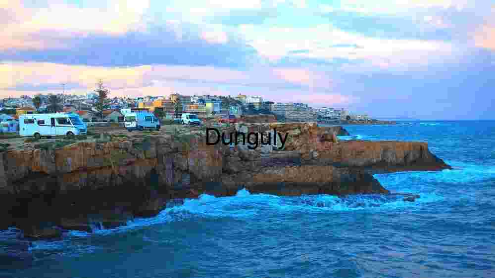 Coastal Cliffside with Camper Vans at Sunset