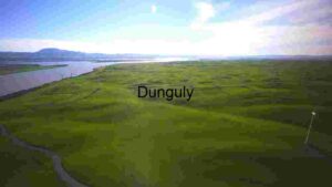 Wind Turbines on Rolling Green Hills by a River