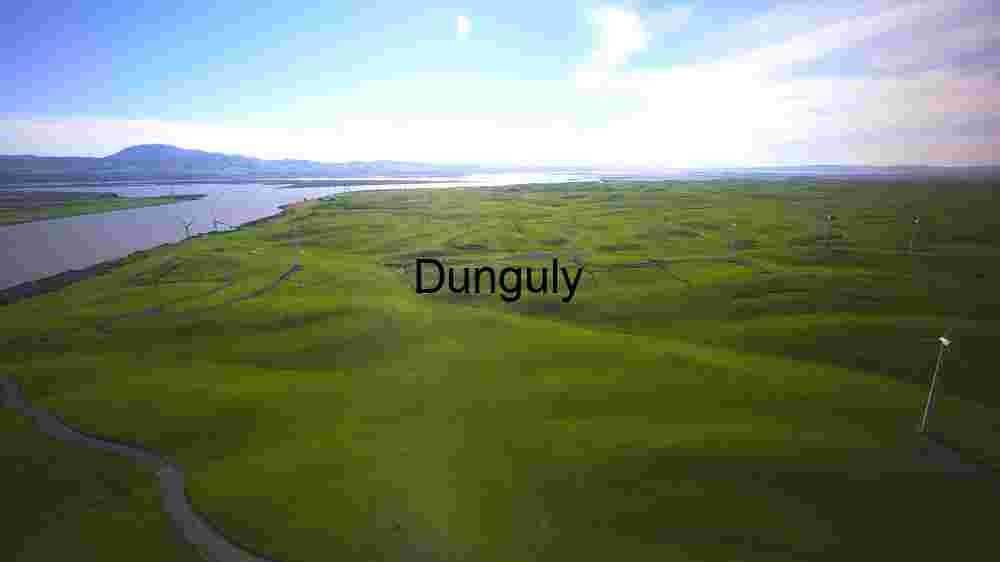 Wind Turbines on Rolling Green Hills by a River