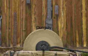 Antique Grindstone Against Wooden Wall