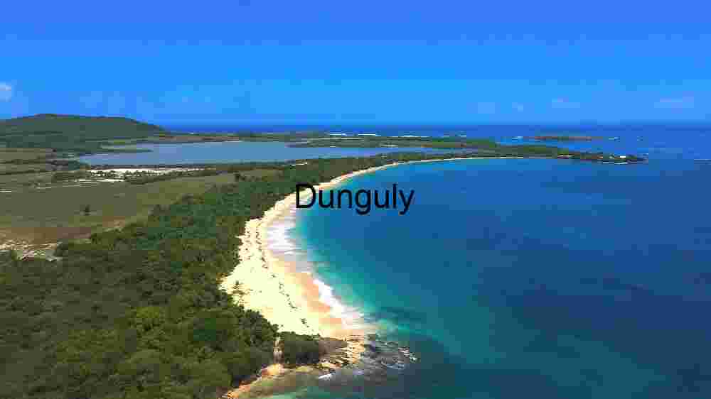 Serene Coastal Landscape with Pristine Beach and Lush Greenery