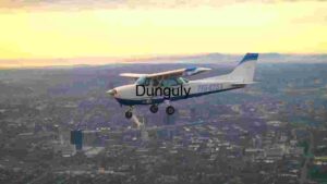 Small Airplane Flying Over Cityscape at Sunset