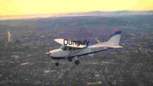Small Aircraft Flying Over Cityscape at Sunset