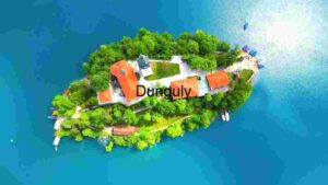 Aerial View of a Serene Island with Red-Roofed Buildings