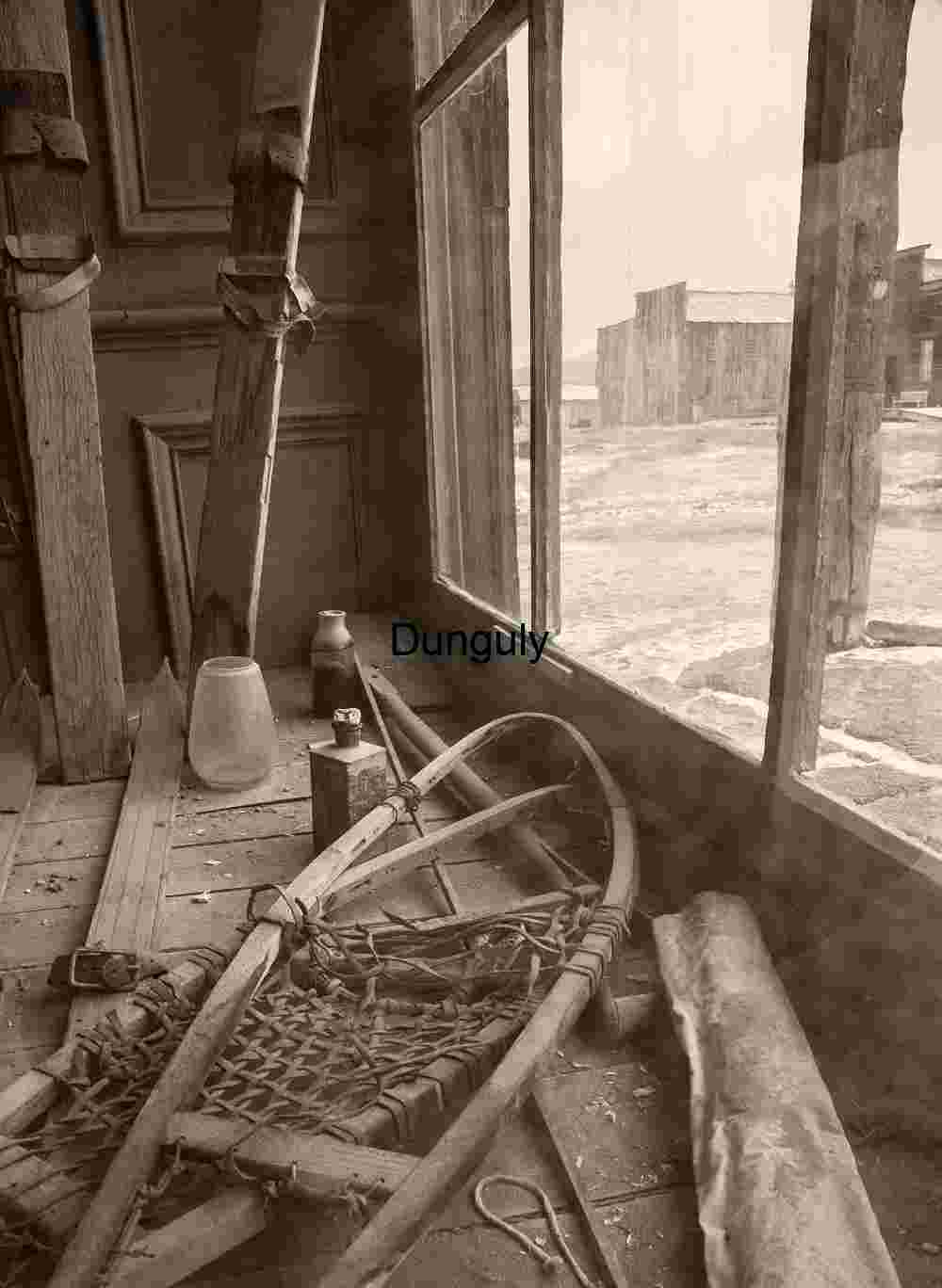 Abandoned Cabin with Vintage Snowshoes and Skis