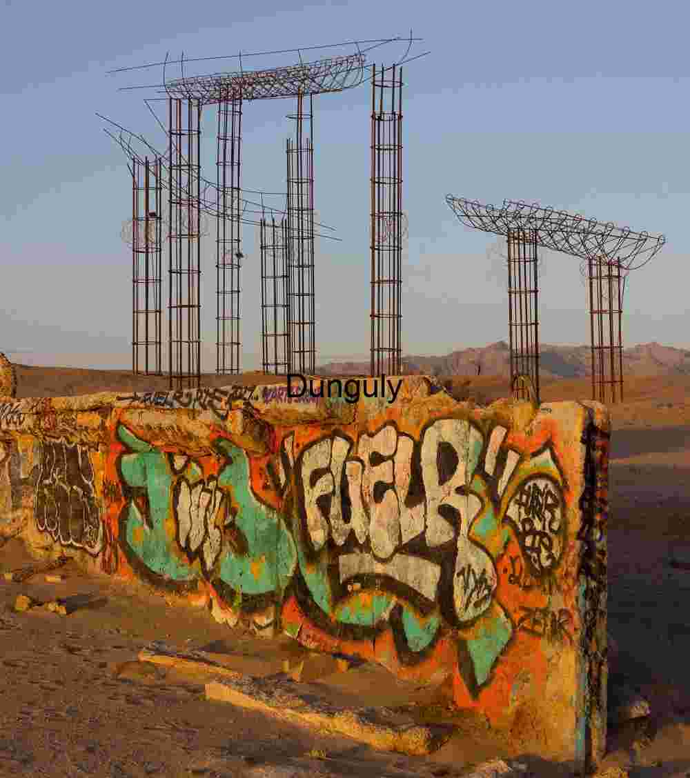 Graffiti Wall and Rebar Monuments in Desert Silence