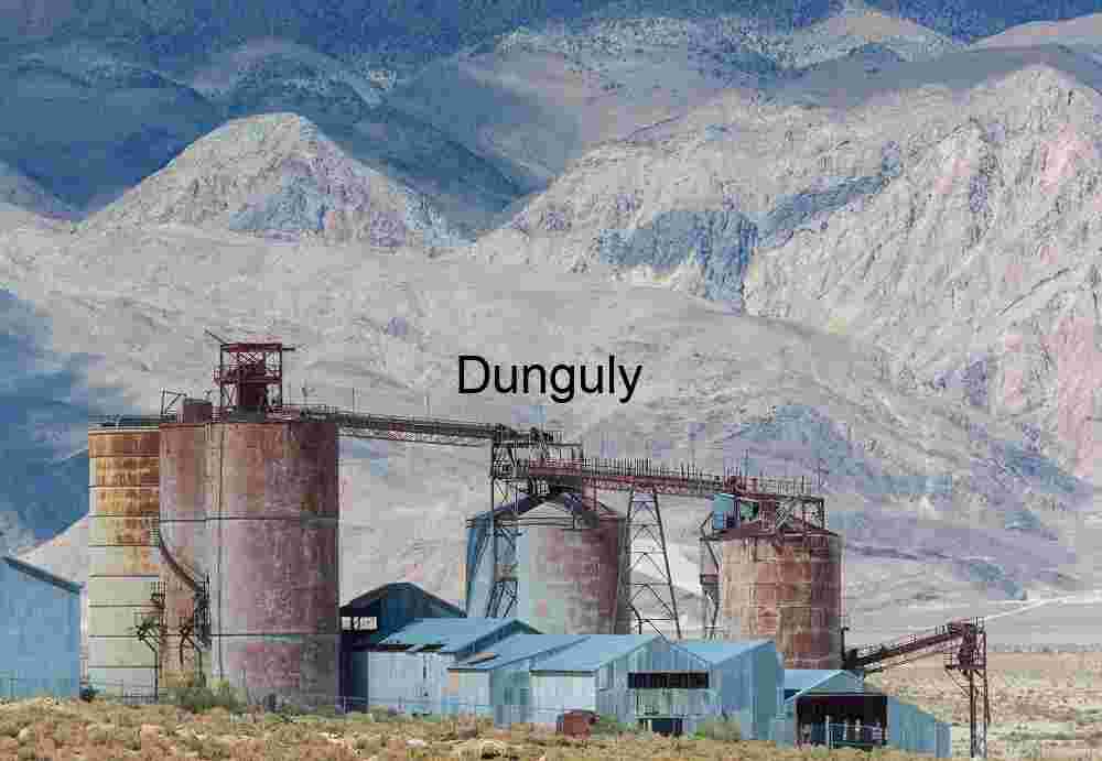 Rust‑Colored Industrial Silos in Mountainous Desert Landscape