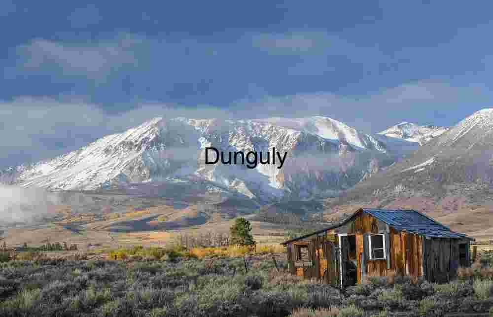 Rustic Shack in Autumn Grassland with Snow‑Capped Mountains