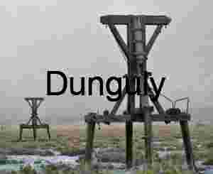 Weathered Wooden Mining Headframe in Dusty Desert