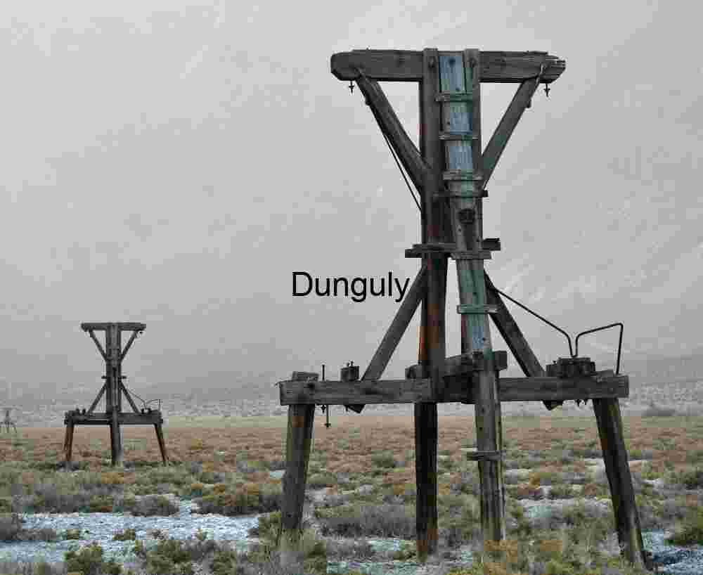 Weathered Wooden Mining Headframe in Dusty Desert