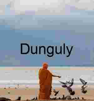 Solitary Figure Feeding Birds on Stormy Beach