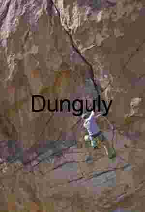 Vertical Grit: Rock Climber Ascending a Textured Cliff