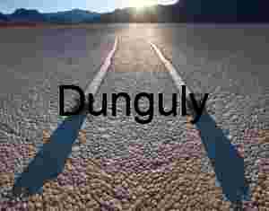 Wide-angle vista of Death Valley’s Racetrack Playa, featuring a single boulder trail amid cracked earth and distant mountain peaks.