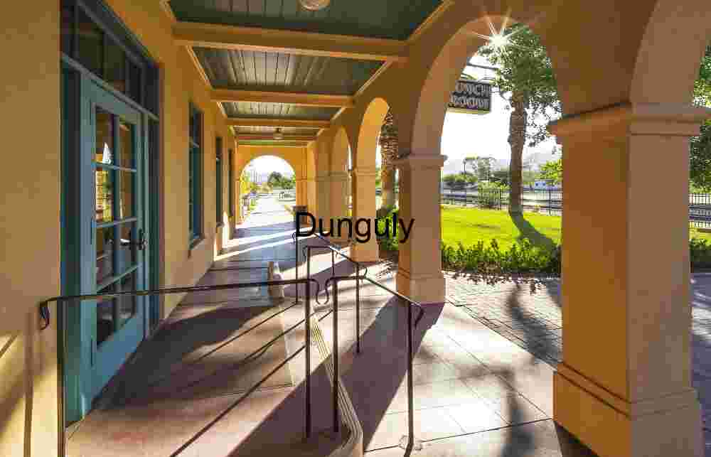 Sunlit Walkway with Arches and Ramp in Public Courtyard