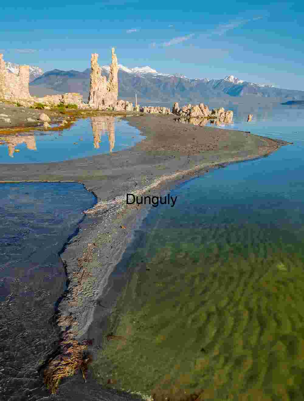Curved Shore, Crystal Depths: Tufa Towers Framing Alpine Horizon