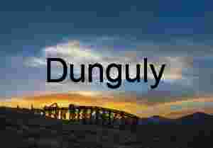 Sunset Silhouette of Abandoned Mining Structure on Mountain Ridge