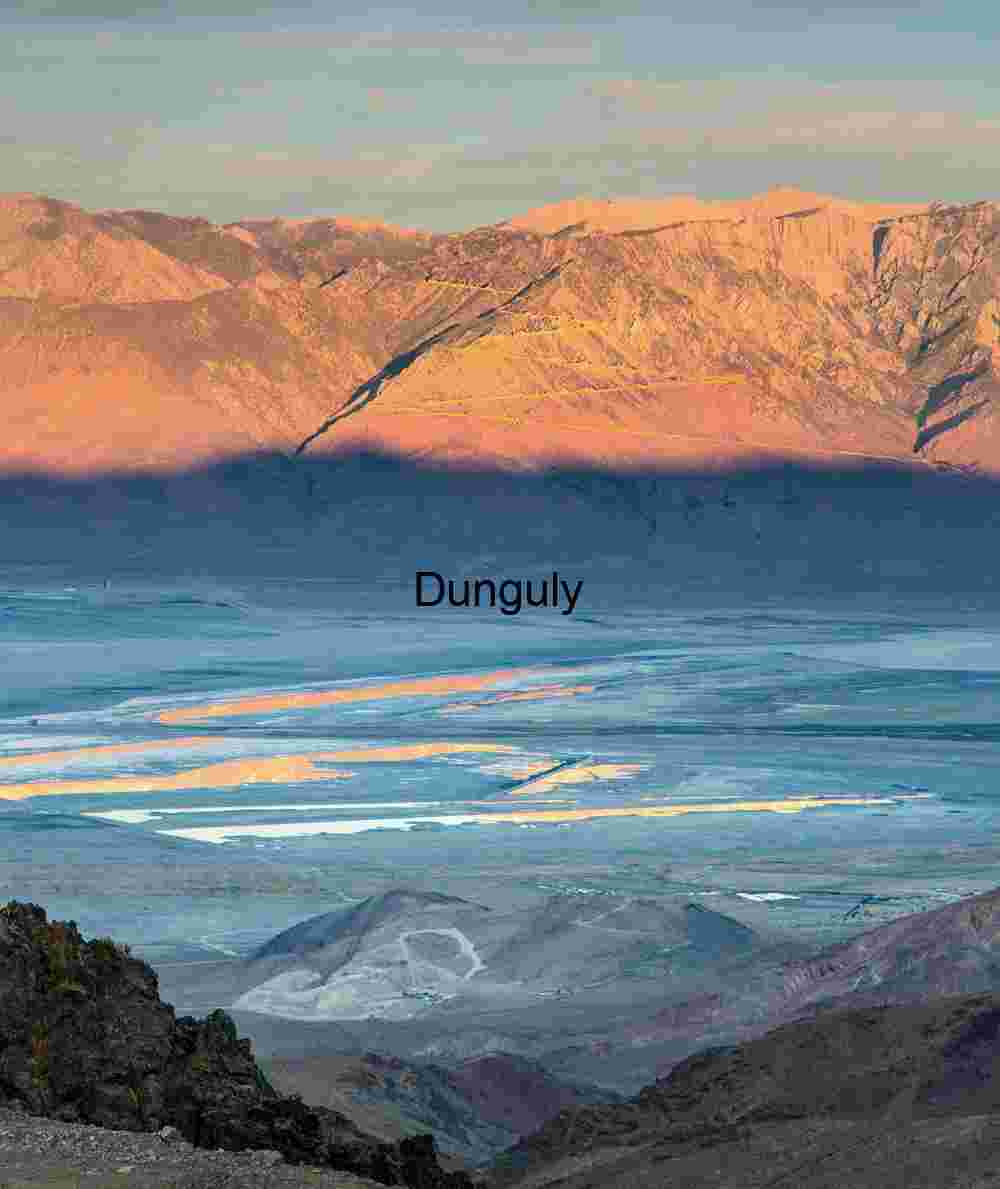 Golden Hour Over Desert Valley Salt Flats – Dramatic Mountain Shadows and Rugged Terrain
