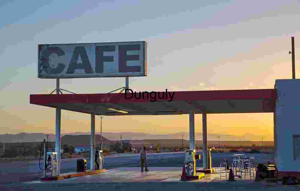 Sunset at Rural Gas Station and Café with Mountain Horizon
