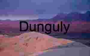 Sunlit Desert Dunes and Reddish Mountains Under Moody Sky