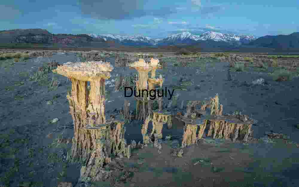 Stone Sentinels: Tufa Towers Beneath Alpine Sky