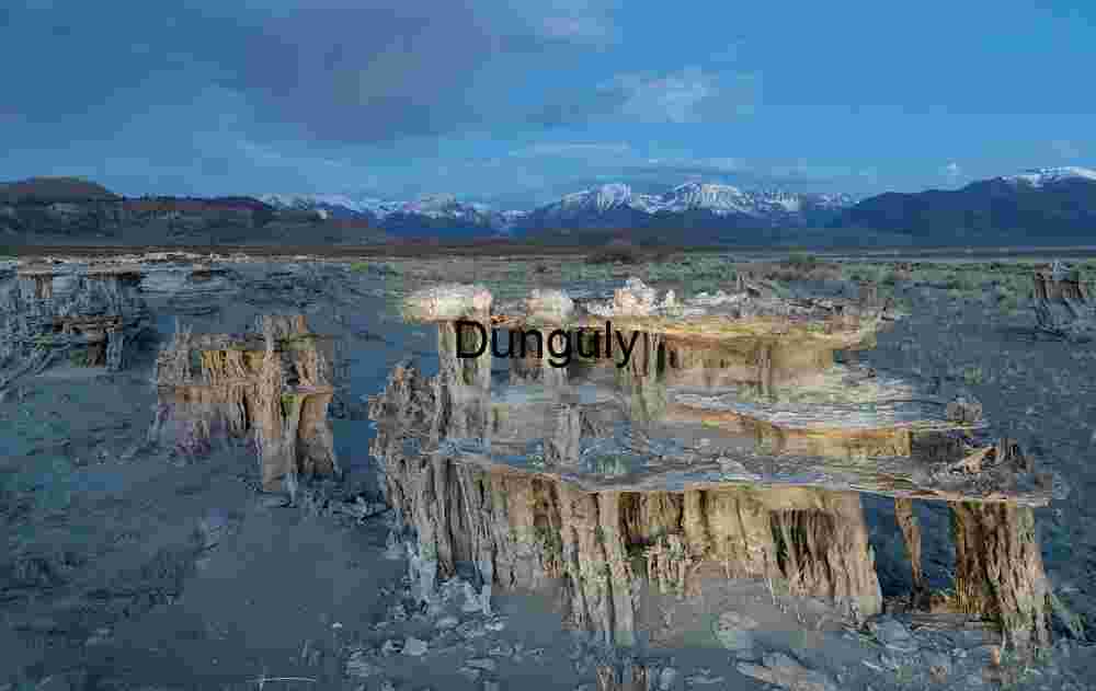 Erosion and Elevation: Tufa Towers Framed by Snow-Capped Peaks