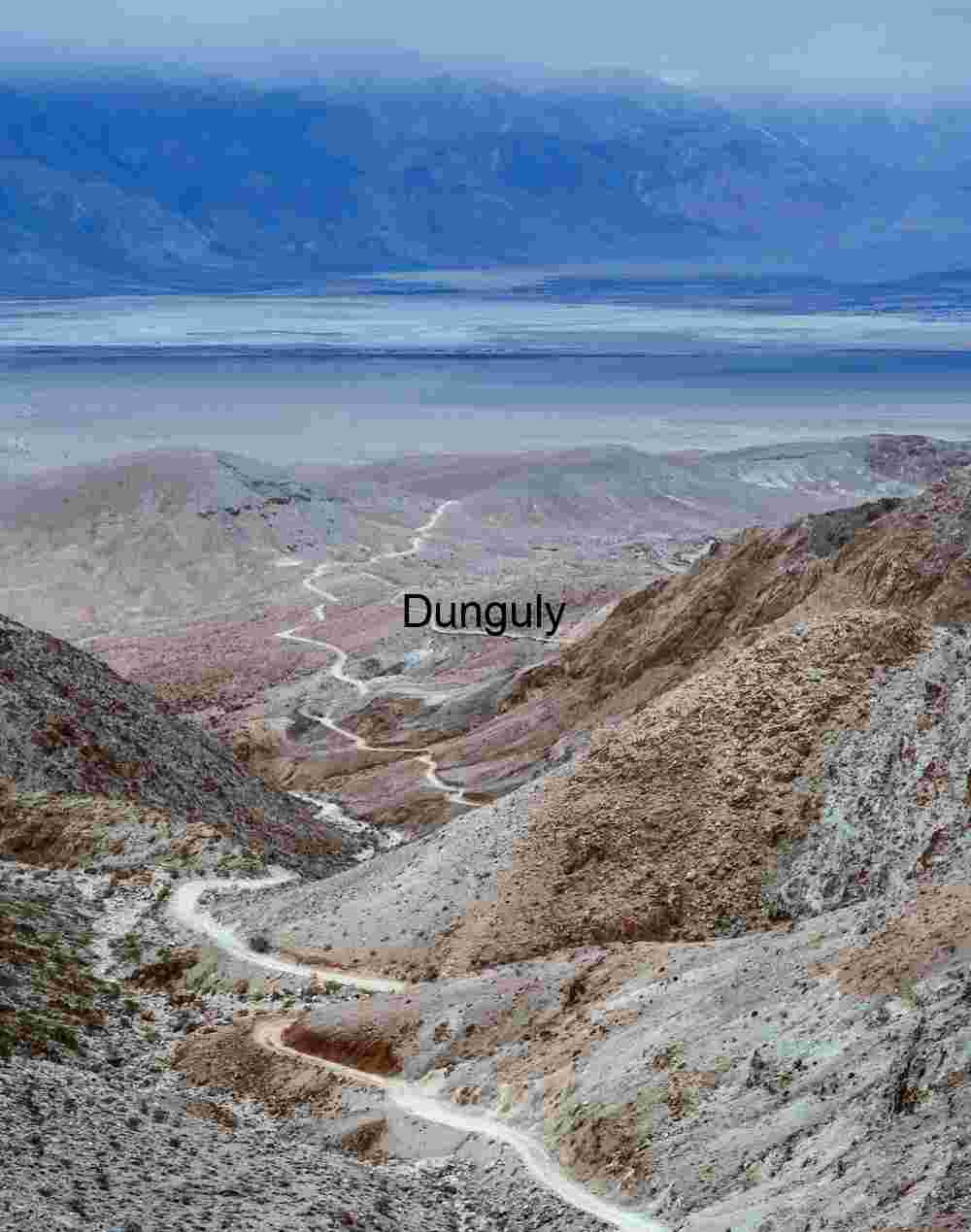 Winding Dirt Road Through Rugged Desert Mountains