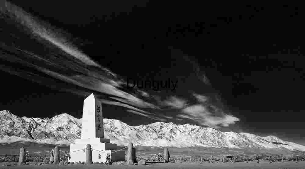 Black and White Monument with Japanese Inscription — Snow‑Covered Mountain Backdrop