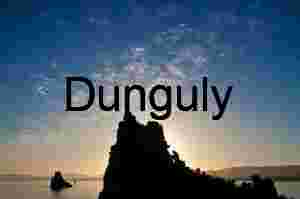 Silhouettes at Dusk: Rocky Outcrop Over Reflective Waters