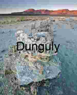 Sunlit Tufa Formations with Mountain Backdrop in Desert Basin