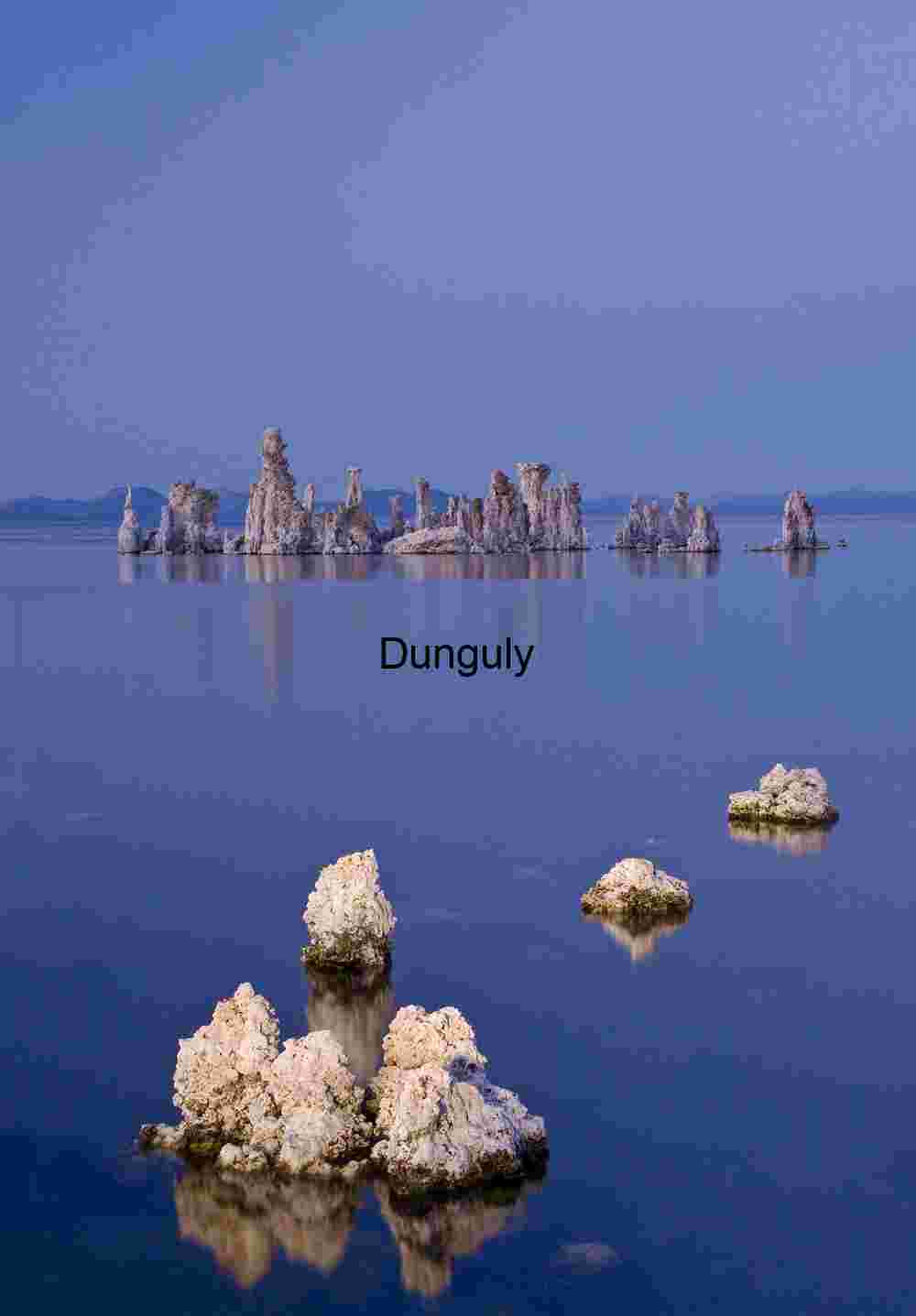Reflections in Still Water: Tufa Towers Beneath a Soft Sky