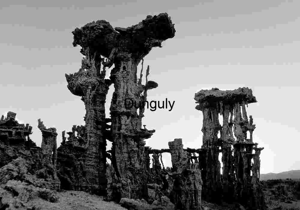 Stone Sentinels: Vertical Tufa Towers Beneath a Clear Twilight Sky
