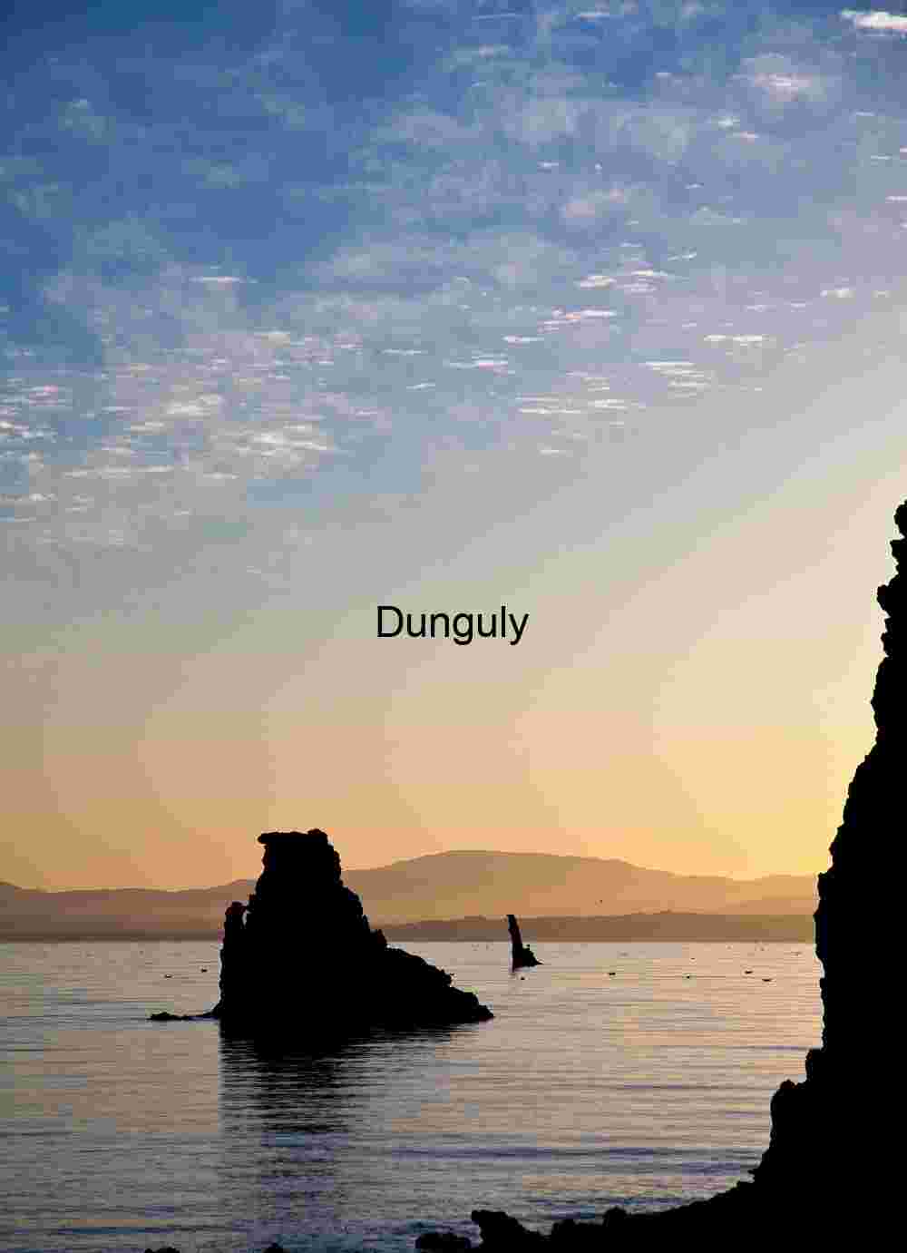 Coastal Rock Silhouettes at Sunrise Over Calm Waters