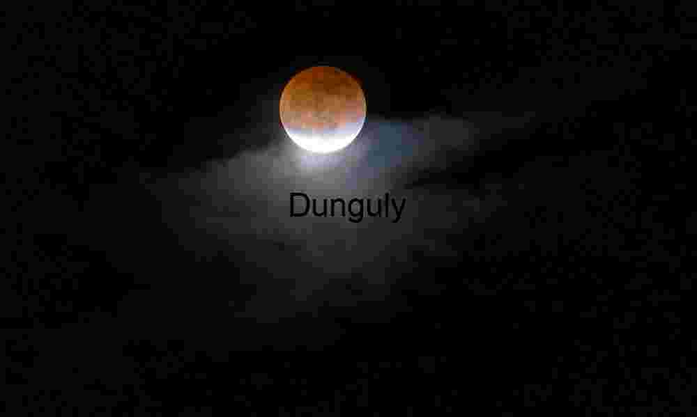 Blood Moon Eclipse Framed by Illuminated Night Clouds