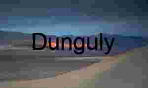 Sunlit Divide: Dunes and Mountains Beneath a Brooding Sky