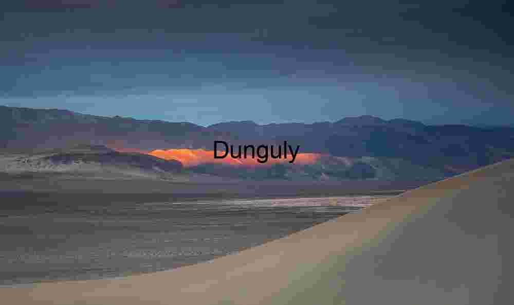 Sunlit Divide: Dunes and Mountains Beneath a Brooding Sky
