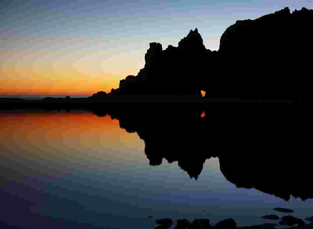 Portal of Light: Coastal Rock Silhouette at Sunset