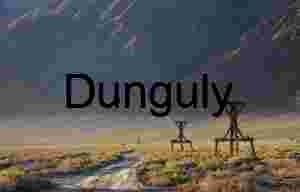 Rusting Oil Derrick Against Rugged Peaks